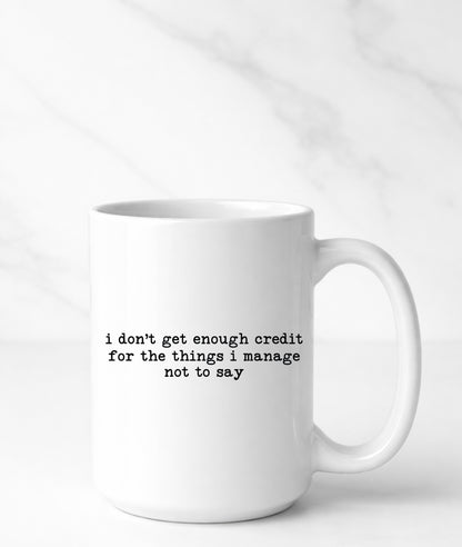 White mug with black text on a white background